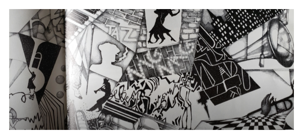 Website picture of jazzy, semi-abstract black and white artwork from a children's book. The link goes to someone reading the book on YouTube